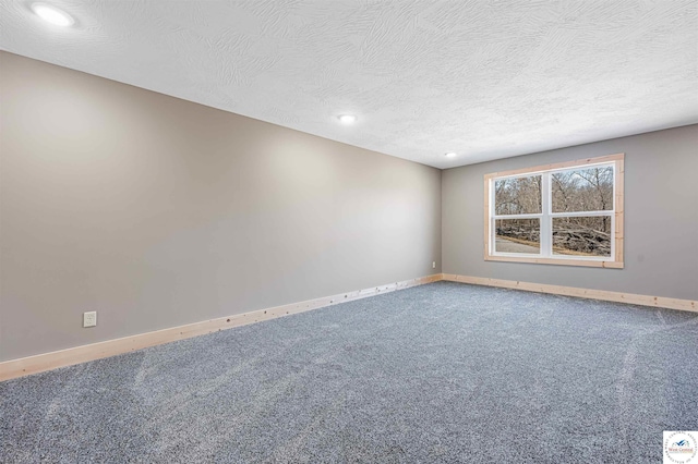 carpeted empty room featuring recessed lighting, a textured ceiling, and baseboards