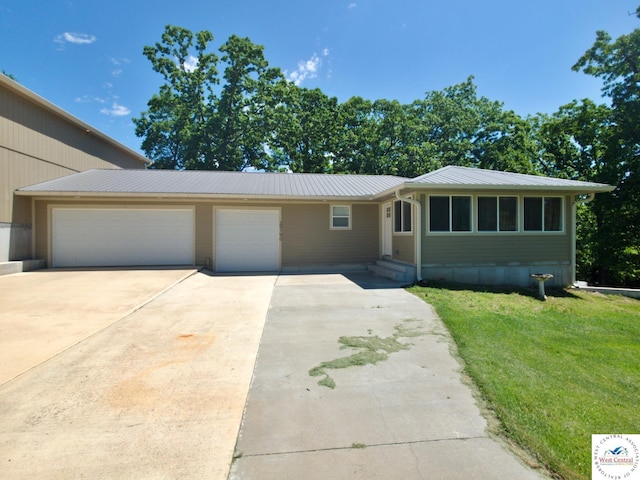 29790 Bobcat Dr, Warsaw, MO 65355 - view of front of property with driveway, an attached garage, a front lawn, and metal roof