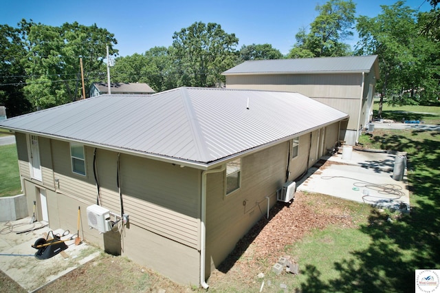 29790 Bobcat Dr, Warsaw, MO 65355 - view of side of property featuring metal roof, a patio, and ac unit