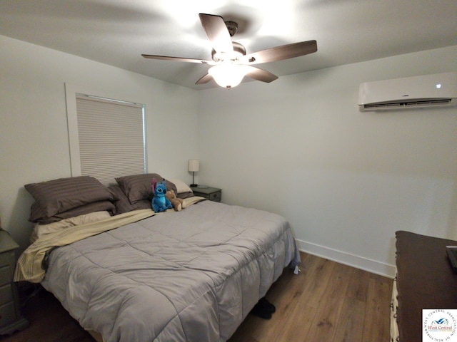 29790 Bobcat Dr, Warsaw, MO 65355 - bedroom featuring a wall mounted AC, wood finished floors, baseboards, and ceiling fan