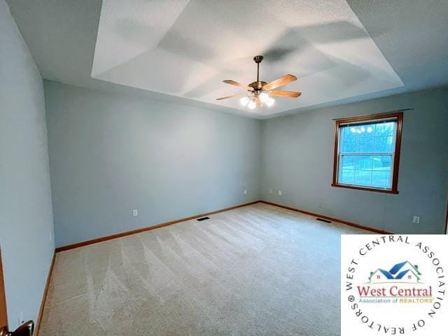 empty room featuring baseboards, ceiling fan, and carpet