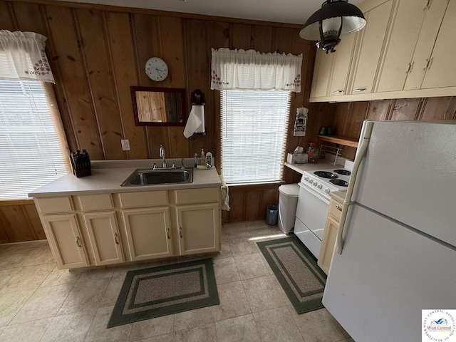 19094 Kennedy Rd, Warsaw, MO 65355 - kitchen featuring white appliances, a sink, wood walls, and light countertops