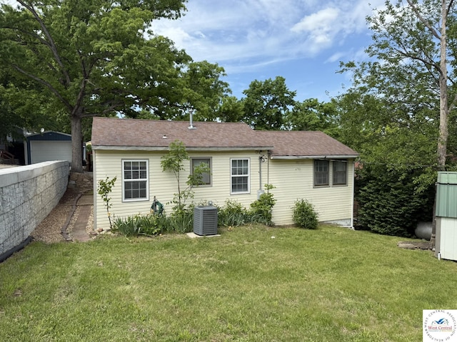 19094 Kennedy Rd, Warsaw, MO 65355 - back of house with central AC unit and a lawn