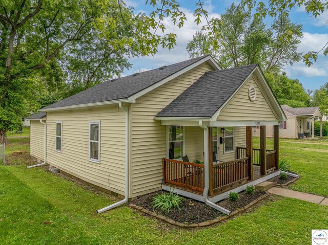 1803 S Quincy Ave, Sedalia, MO 65301 - view of property exterior with a porch, a shingled roof, and a yard