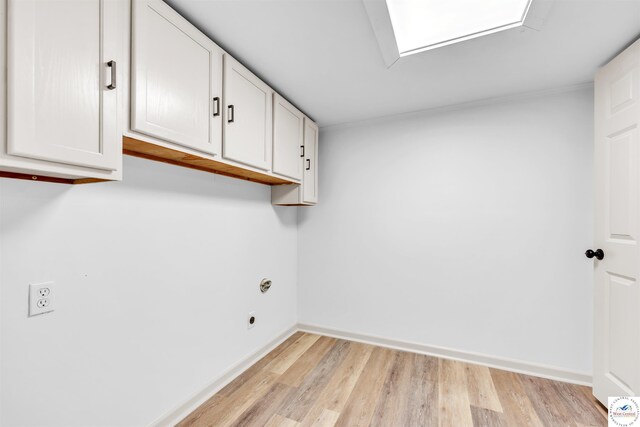 1803 S Quincy Ave, Sedalia, MO 65301 - laundry room with hookup for an electric dryer, cabinet space, and light wood finished floors