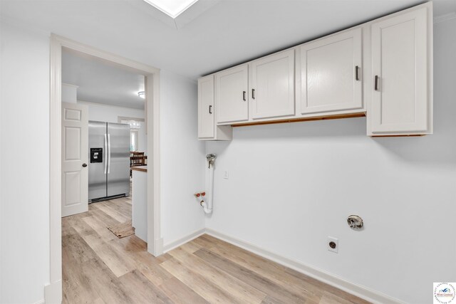 1803 S Quincy Ave, Sedalia, MO 65301 - washroom featuring light wood-type flooring, cabinet space, hookup for an electric dryer, and baseboards