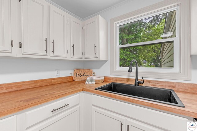 1803 S Quincy Ave, Sedalia, MO 65301 - kitchen with a sink, butcher block counters, and white cabinetry