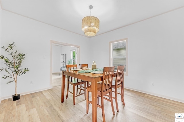1803 S Quincy Ave, Sedalia, MO 65301 - dining space featuring light wood-style flooring, baseboards, and a chandelier