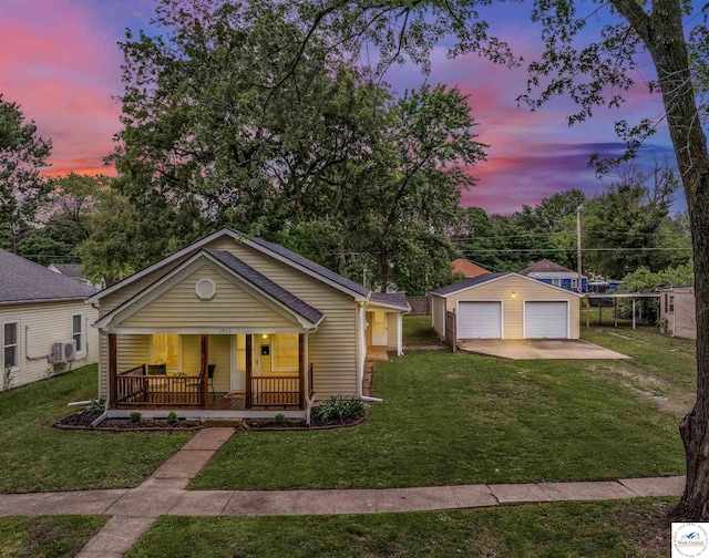 1803 S Quincy Ave, Sedalia, MO 65301 - view of front of house with a porch, a detached garage, an outdoor structure, a front lawn, and driveway