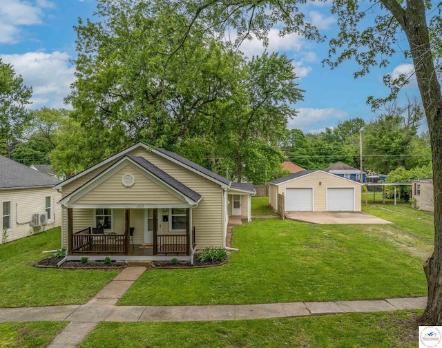 1803 S Quincy Ave, Sedalia, MO 65301 - view of front of home with covered porch, a detached garage, an outbuilding, and a front lawn