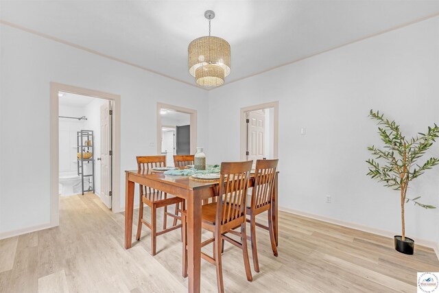 1803 S Quincy Ave, Sedalia, MO 65301 - dining area with light wood-style floors, a chandelier, and baseboards