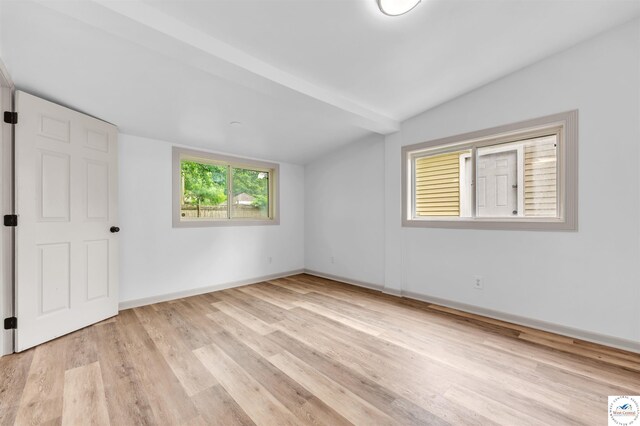 1803 S Quincy Ave, Sedalia, MO 65301 - unfurnished bedroom with lofted ceiling, light wood-style floors, and baseboards