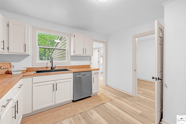 1803 S Quincy Ave, Sedalia, MO 65301 - kitchen with dishwasher, a sink, light wood-type flooring, white cabinets, and wood counters