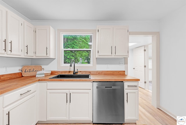 1803 S Quincy Ave, Sedalia, MO 65301 - kitchen featuring stainless steel dishwasher, a sink, butcher block countertops, white cabinetry, and light wood finished floors