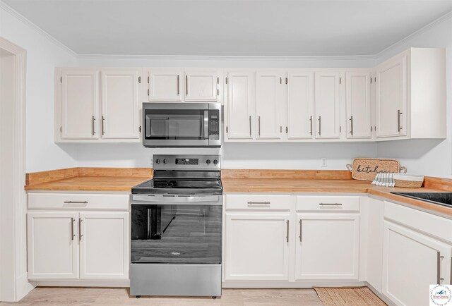 1803 S Quincy Ave, Sedalia, MO 65301 - kitchen featuring stainless steel appliances, light wood finished floors, crown molding, and white cabinetry