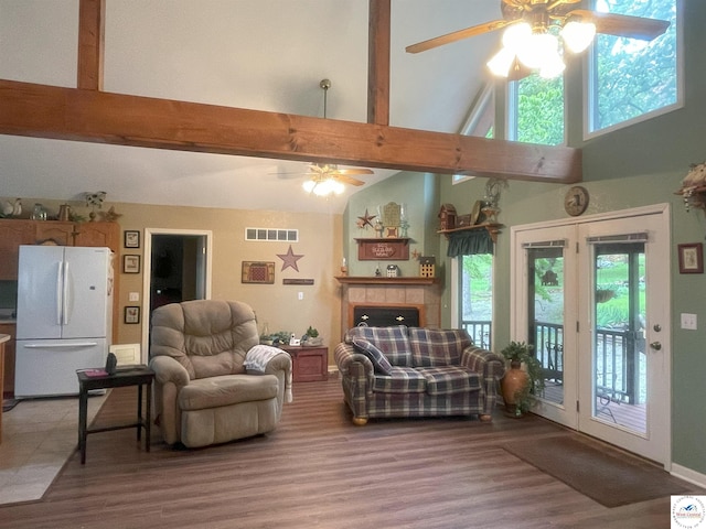 791 SE 1211th Rd, Deepwater, MO 64740 - living room with ceiling fan, high vaulted ceiling, beam ceiling, light wood-style floors, and a tile fireplace