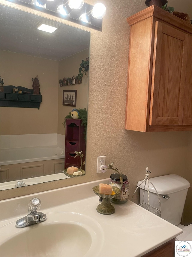 791 SE 1211th Rd, Deepwater, MO 64740 - bathroom with vanity, a textured wall, and a garden tub