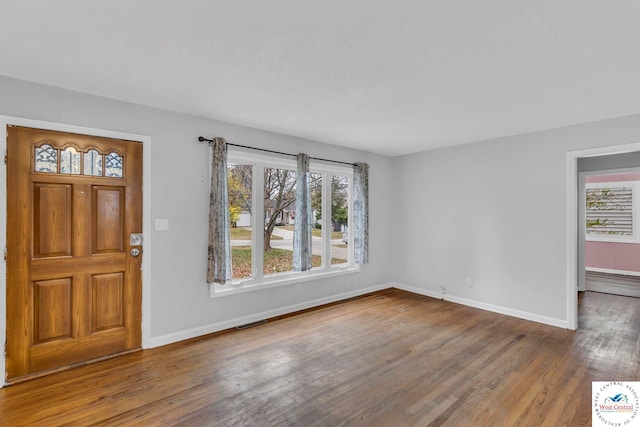 6204 E 147th Ter, Grandview, MO 64030 - foyer featuring wood finished floors, healthy amount of natural light, and baseboards