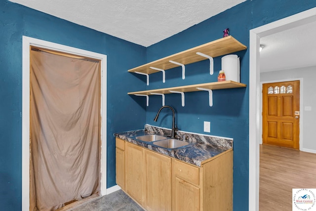 6204 E 147th Ter, Grandview, MO 64030 - kitchen featuring a sink, open shelves, a textured ceiling, baseboards, and light brown cabinets