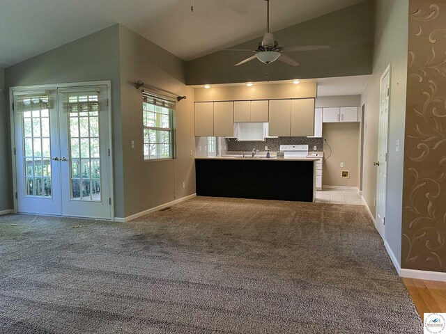 845 Ww Hwy, Osceola, MO 64776 - kitchen featuring lofted ceiling, white cabinets, ceiling fan, baseboards, and french doors