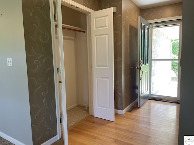845 Ww Hwy, Osceola, MO 64776 - foyer featuring light wood-style floors, baseboards, and wallpapered walls