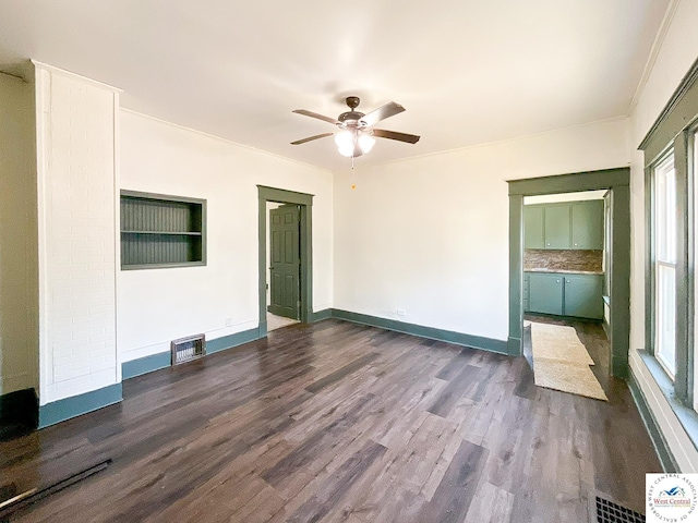 unfurnished living room with baseboards, visible vents, ceiling fan, and dark wood finished floors