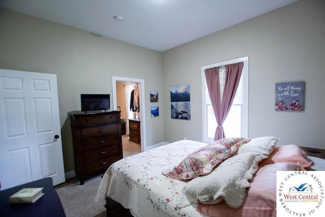 1625 W 16th St, Sedalia, MO 65301 - bedroom with light colored carpet and a walk in closet