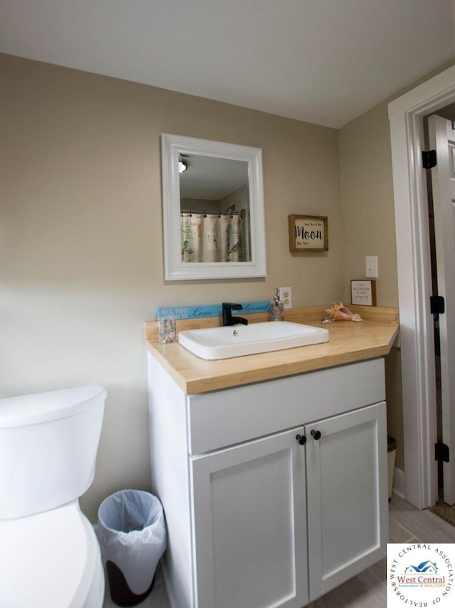 1625 W 16th St, Sedalia, MO 65301 - bathroom with vanity and toilet