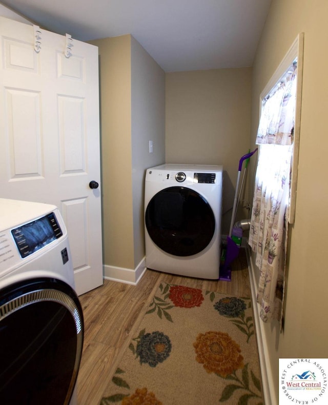 1625 W 16th St, Sedalia, MO 65301 - laundry area with washer / clothes dryer, wood finished floors, and baseboards