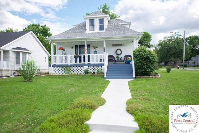 1625 W 16th St, Sedalia, MO 65301 - bungalow-style home with a porch, roof with shingles, and a front lawn