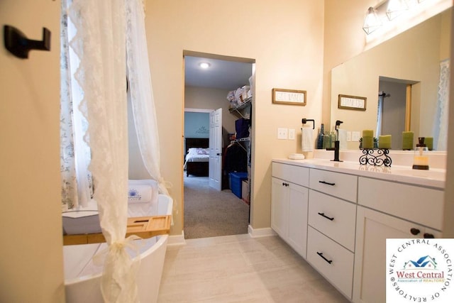 1625 W 16th St, Sedalia, MO 65301 - bathroom with vanity, ensuite bath, and baseboards