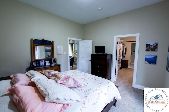 1625 W 16th St, Sedalia, MO 65301 - carpeted bedroom featuring a walk in closet and baseboards