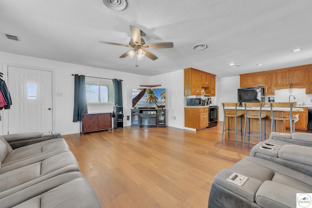 216 S County Line Rd, Windsor, MO 65360 - living room with a ceiling fan, light wood finished floors, baseboards, a textured ceiling, and recessed lighting