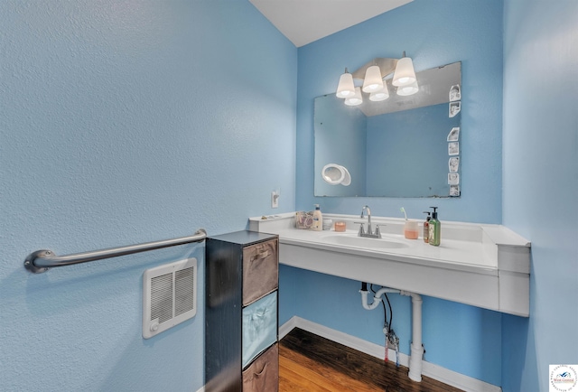 216 S County Line Rd, Windsor, MO 65360 - bathroom with a sink, wood finished floors, and heating unit
