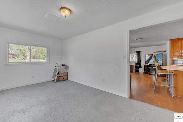 216 S County Line Rd, Windsor, MO 65360 - spare room featuring baseboards and a textured ceiling