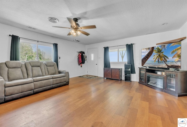 216 S County Line Rd, Windsor, MO 65360 - living room featuring a textured ceiling, hardwood / wood-style flooring, ceiling fan, and plenty of natural light