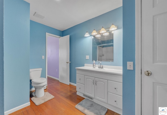 216 S County Line Rd, Windsor, MO 65360 - full bath with toilet, vanity, a shower with door, wood finished floors, and baseboards