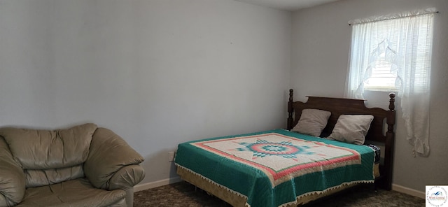 bedroom featuring carpet floors and baseboards