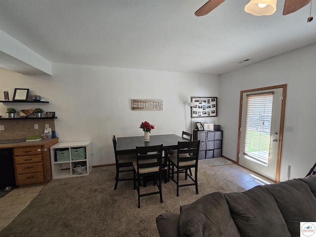 dining space featuring visible vents, a ceiling fan, and light tile patterned flooring
