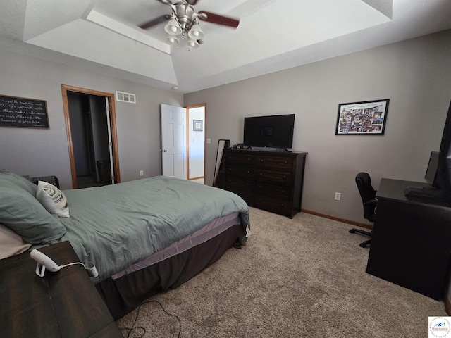 carpeted bedroom featuring lofted ceiling, visible vents, ceiling fan, and baseboards