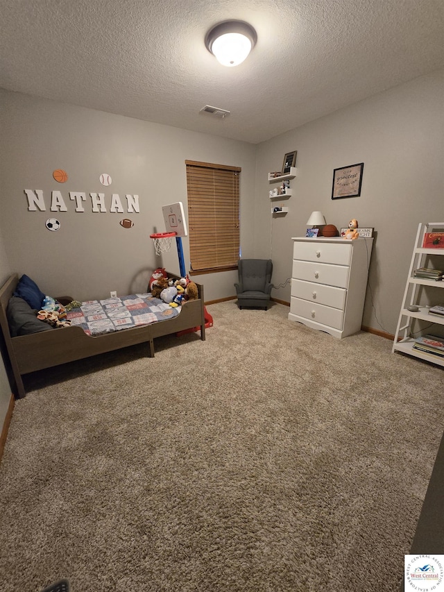carpeted bedroom featuring visible vents and a textured ceiling