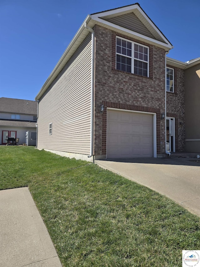 view of side of home featuring driveway, a yard, an attached garage, and brick siding