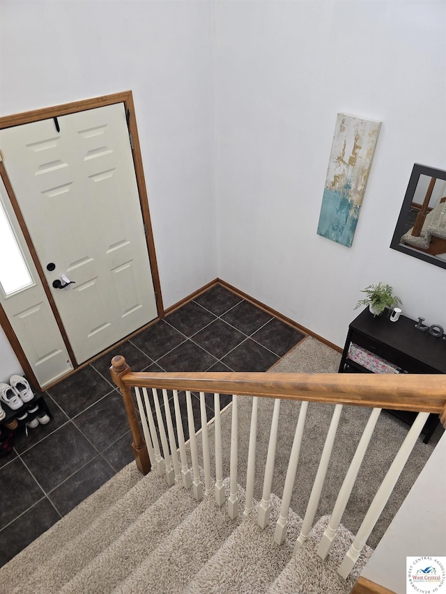 stairway featuring tile patterned floors