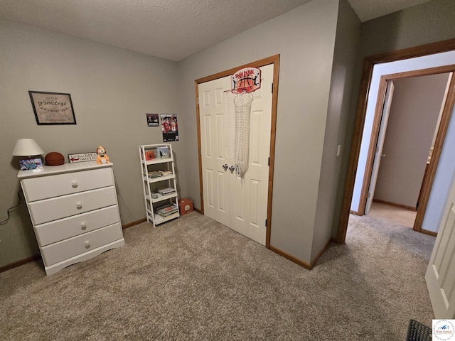 bedroom with baseboards and carpet