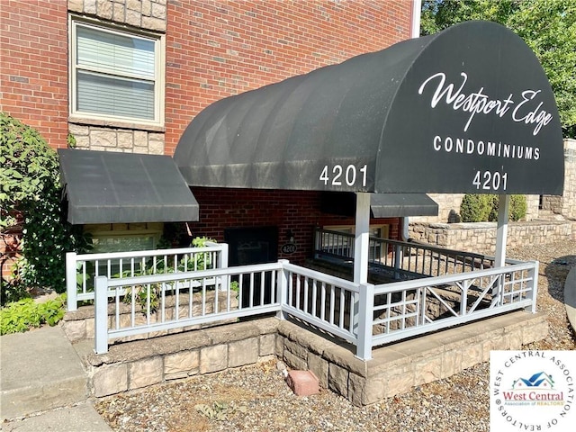 entrance to property featuring brick siding