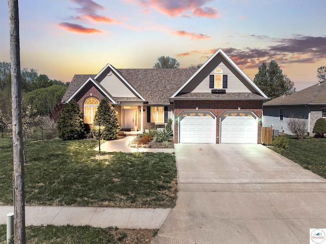 view of front of home featuring a garage, brick siding, a yard, roof with shingles, and concrete driveway
