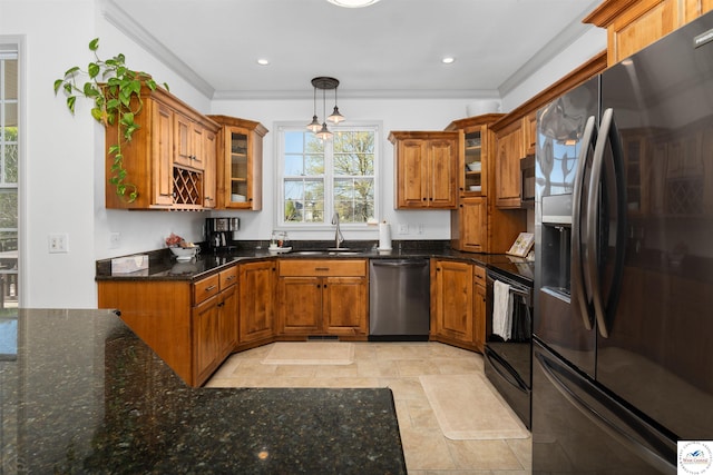 kitchen with brown cabinetry, stainless steel dishwasher, refrigerator with ice dispenser, and a sink