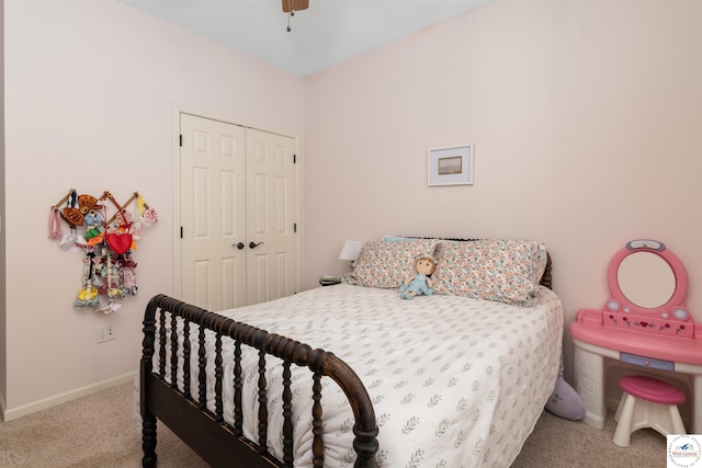carpeted bedroom with a closet, ceiling fan, and baseboards