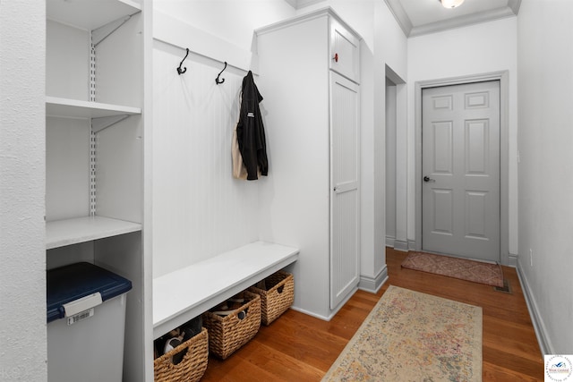 mudroom with baseboards, wood finished floors, and ornamental molding
