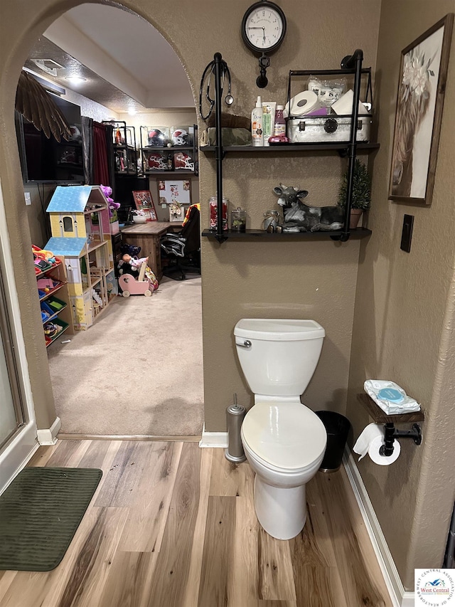 34443 Peters Ave, Warsaw, MO 65355 - bathroom with toilet, a textured wall, wood finished floors, and baseboards